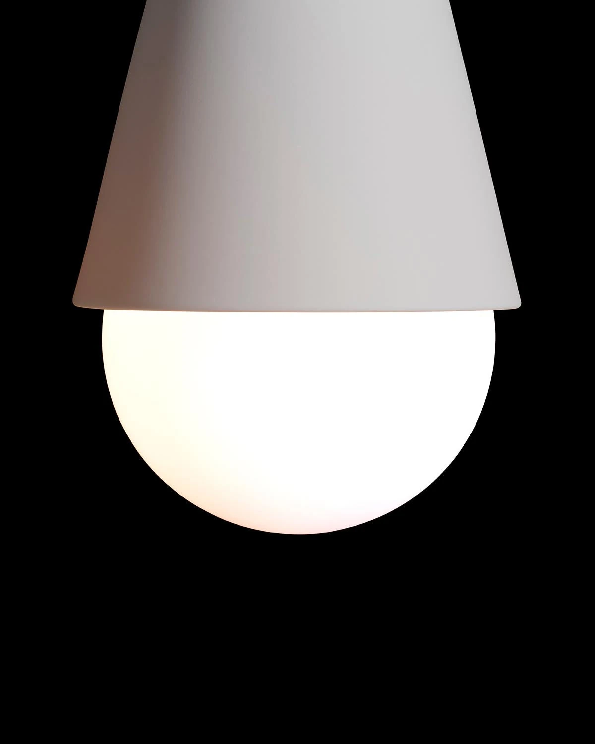 Close-up of the porcelain cone and frosted LED sphere on the TRIAD : 1 Sconce