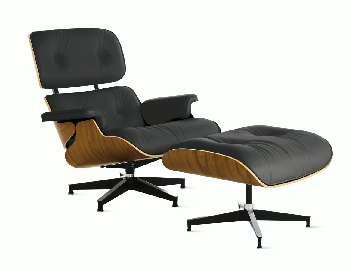 Three-quarter view of the Eames Lounge Chair and Ottoman in oiled walnut and black leather